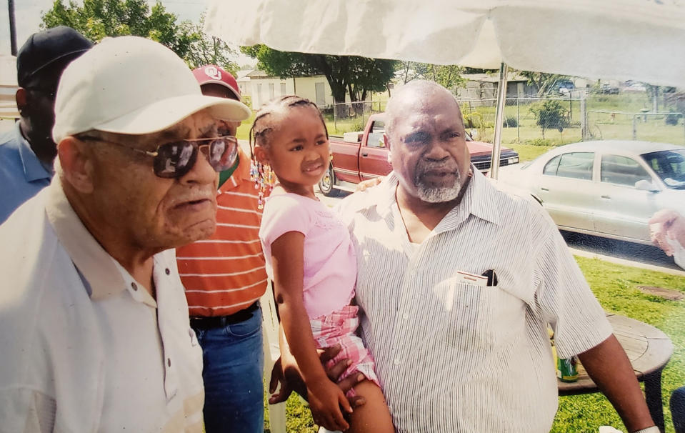 Hughes Van Ellis (left), Shani Howard (center) and James Ford (right) celebrate Viola Fletcher's 100th birthday party in Bartlesville, Okla., on May 5, 2014.<span class="copyright">Courtesy Ike Howard</span>