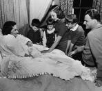 <p>Rev. Billy Graham says goodbye to his wife, Ruth, and their five children on Jan. 15, 1958, before leaving on a crusade in eight Latin American countries. (Photo: AP) </p>