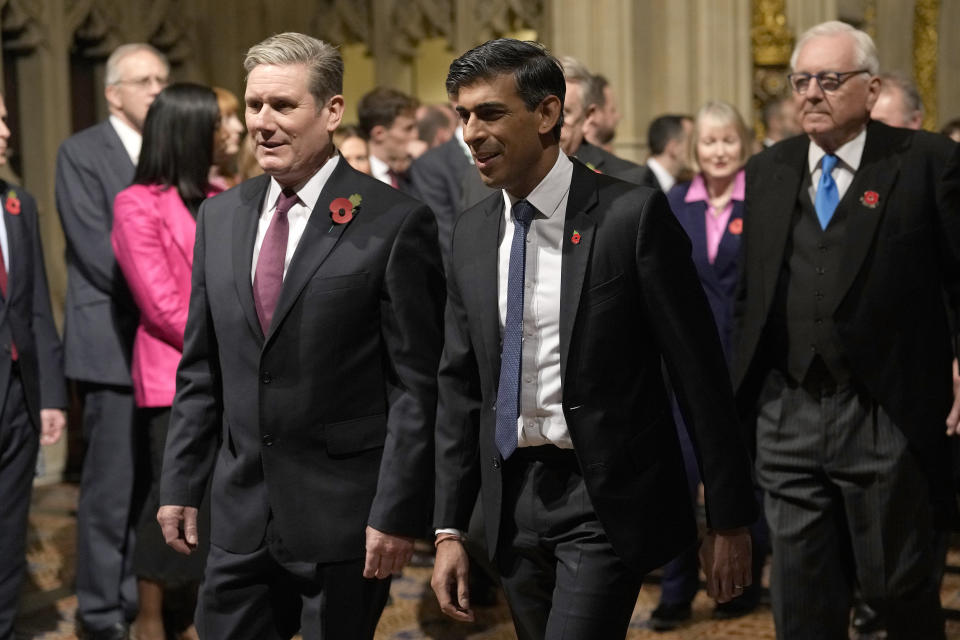 FILE - Britain's Prime Minister Rishi Sunk, right, and Labour Party leader Keir Starmer pass through the Peer's Lobby to attend the State Opening of Parliament, at the Palace of Westminster in London, Tuesday, Nov. 7, 2023. (AP Photo/Alastair Grant, Pool, File)