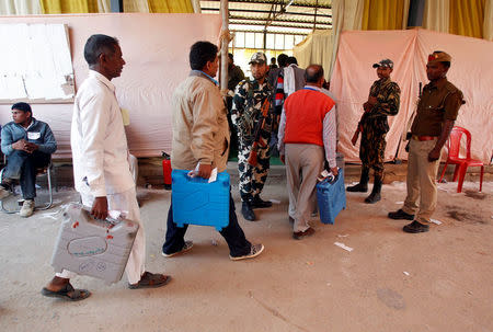 Election officials carry electronic voting machines (EVMs) as they arrive to count votes of the Uttar Pradesh assembly elections at a counting center in Allahabad, Uttar Pradesh, March 11, 2017. REUTERS/Jitendra Prakash