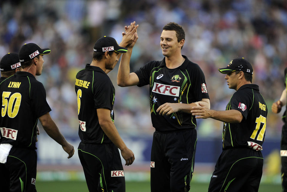 Australia's Josh Hazelwood, center celebrates with teammates after capturing the the wicket of England's Michael Lumb during their T20 International cricket match at the Melbourne Cricket Ground in Melbourne, Australia, Friday, Jan. 31, 2014. (AP Photo/Andy Brownbill)