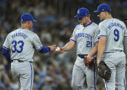Kansas City Royals pitcher Tyler Duffey (21) gets pulled by Royals manager Matt Quatraro (33) as Royals first baseman Vinnie Pasquantino (9) looks on while playing against the Toronto Blue Jays during the fifth inning of baseball game in Toronto on Monday, April 29, 2024. (Nathan Denette/The Canadian Press via AP)
