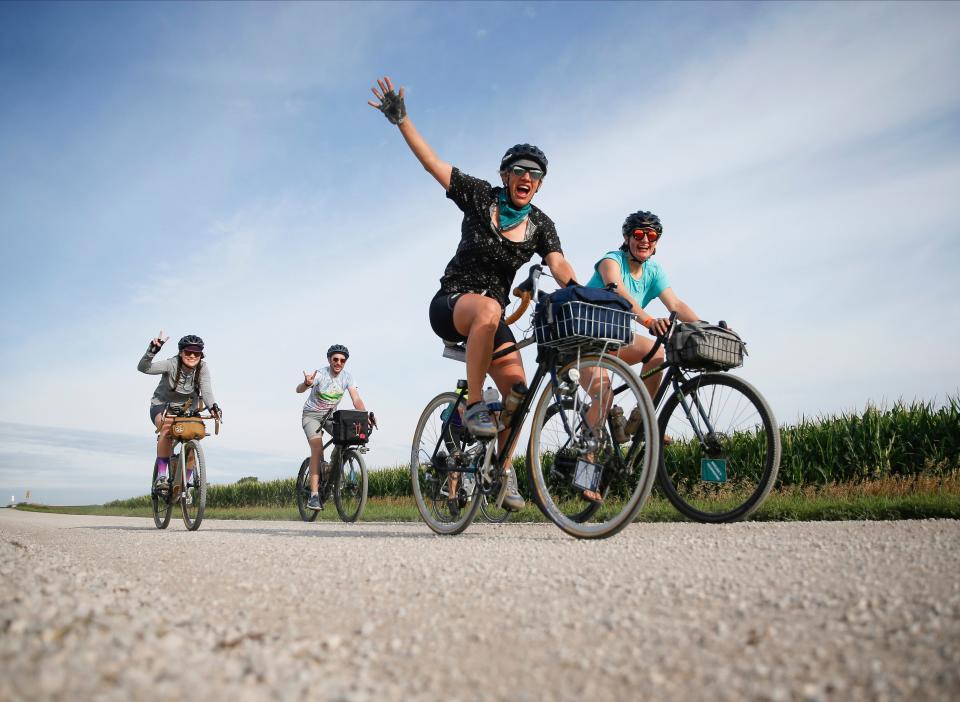 Cyclists ride the optional gravel route into the town of Rolfe after leaving Pocahontas on Tuesday during RAGBRAI.