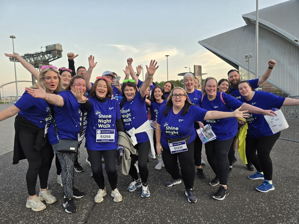 Ash's Army who raised more than £5,000 for Cancer Research UK at Shine Night Walk Glasgow. (Cancer Research UK/SWNS)