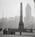<p>Through a foggy haze, you can make out the triangular shape of the Flatiron Building, originally named the Fuller Building. The building was one of the tallest in the city when it was completed in 1902.</p>