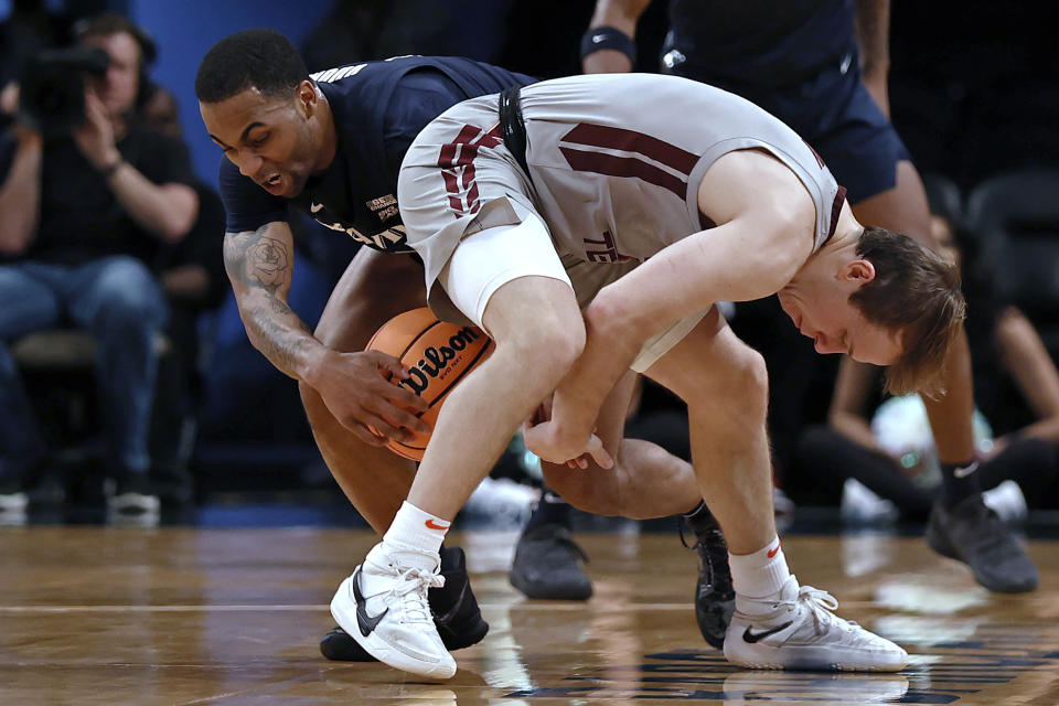 Xavier's Dwon Odom takes the ball from Virginia Tech's Storm Murphy during the first half of an NCAA college basketball game in the NIT Season Tip-Off tournament Friday, Nov. 26, 2021, in New York. (AP Photo/Adam Hunger)