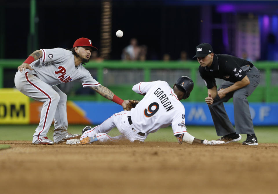 Philadelphia Phillies shortstop Freddy Galvis is unable to hang on to the throw as Miami Marlins’ Dee Gordon (9) slides into second base before advancing to third as second base umpire Roberto Ortiz looks on during the fifth inning of a baseball game, Thursday, Aug. 31, 2017, in Miami. (AP Photo/Wilfredo Lee)