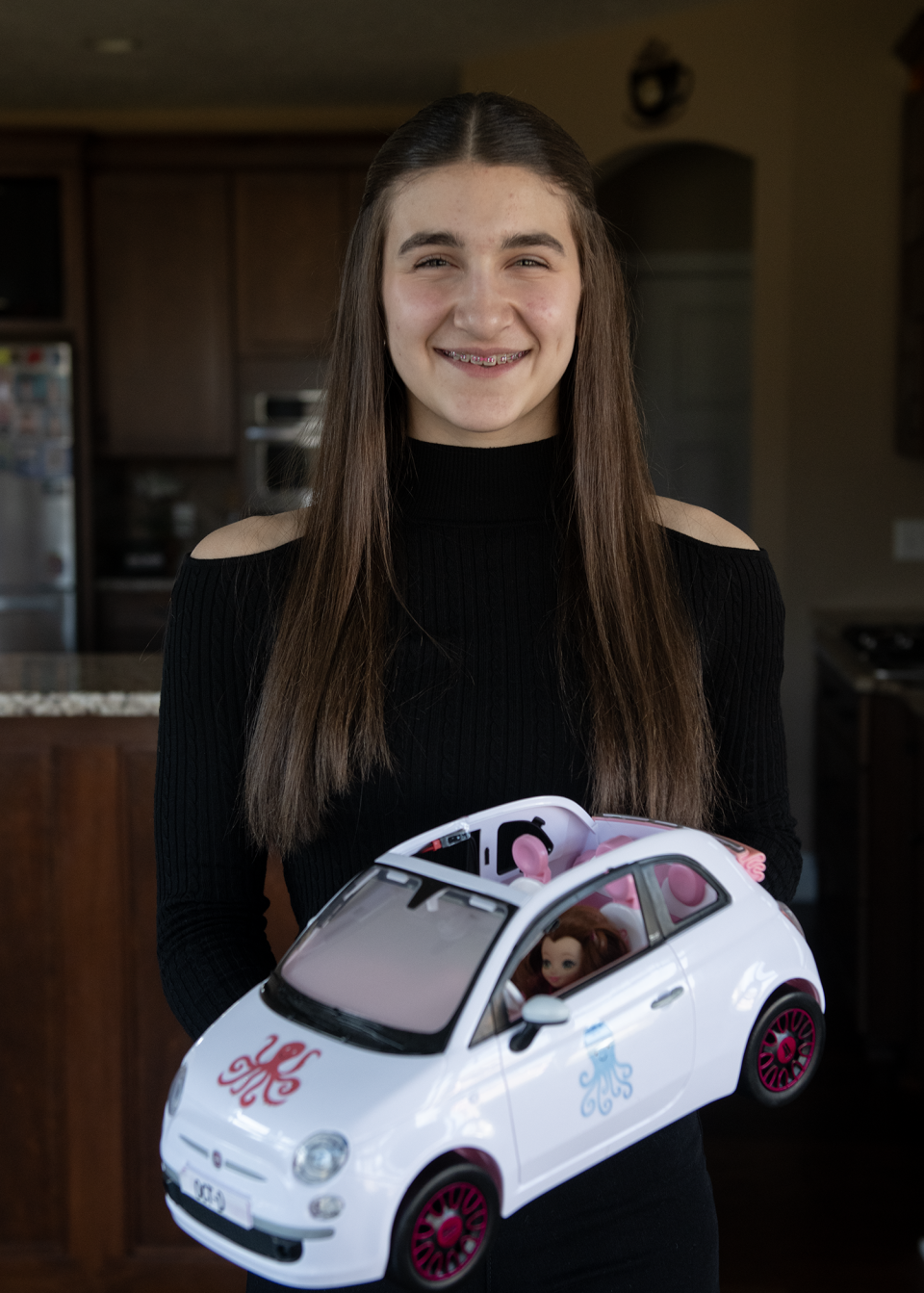 Ava-Elizabeth Bell at her home in Rootstown with her OCT-D Defense For Your Car invention.