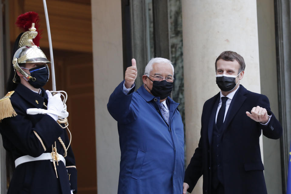 French President Emmanuel Macron, right, welcomes Portuguese Prime Minister Antonio Costa before a working lunch at the Elysee Palace Wednesday, Dec. 16, 2020 in Paris. (AP Photo/Francois Mori)