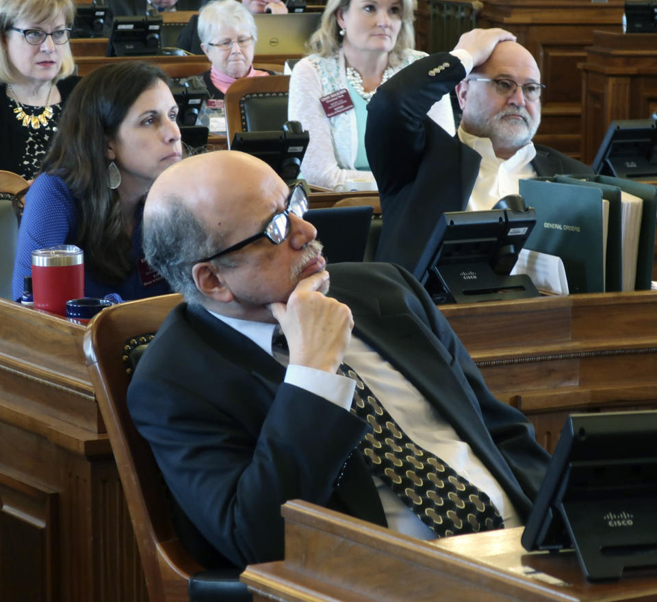 Democrats in the Kansas House, led by Minority Leader Tom Sawyer, front, D-Wichita, follow a debate on Democratic Gov. Laura Kelly's school funding plan, Thursday, April 4, 2019, at the Statehouse in Topeka, Kansas. Lawmakers are not sure that Kelly's plan for an increase in education of funding of roughly $90 million a year will satisfy a Kansas Supreme Court mandate. (AP Photo/John Hanna)