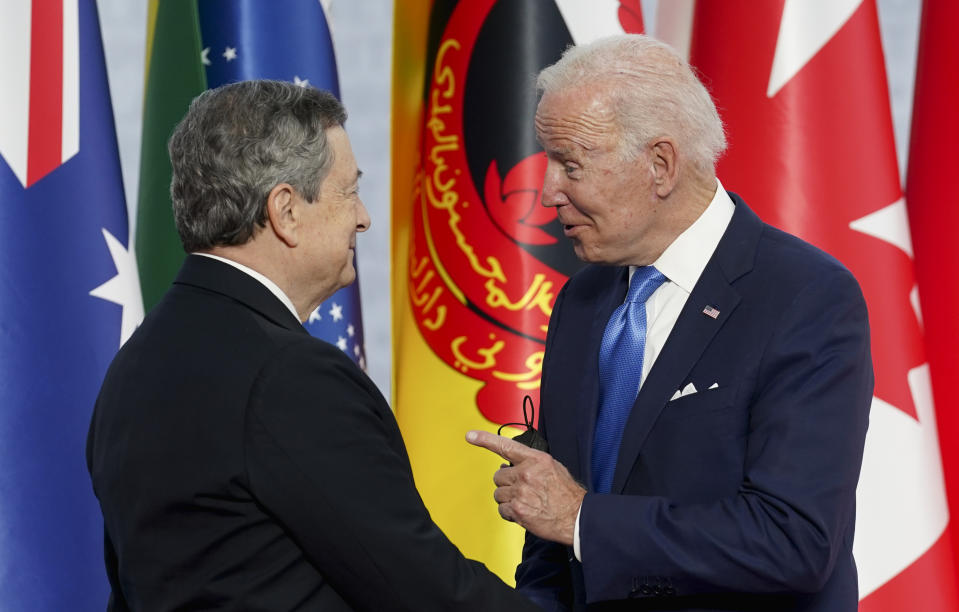 U.S. President Joe Biden, right, speaks with Italy's Prime Minister Mario Draghi as he arrives at the La Nuvola conference center for the G20 summit in Rome, Saturday, Oct. 30, 2021. The two-day Group of 20 summit is the first in-person gathering of leaders of the world's biggest economies since the COVID-19 pandemic started. (Kevin Lamarque/Pool Photo via AP)