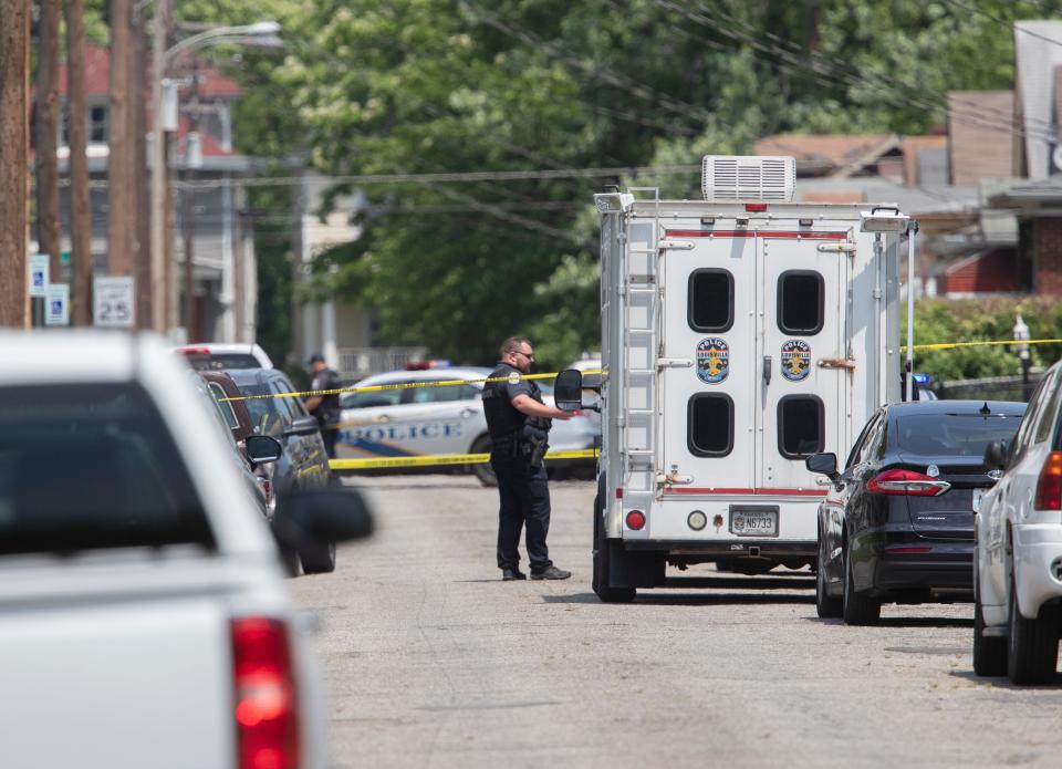 A Metro Louisville policeman works the scene of an officer involved shooting death on Sutcliffe Avenue, in Louisville's West End neighborhood. May 20, 2022