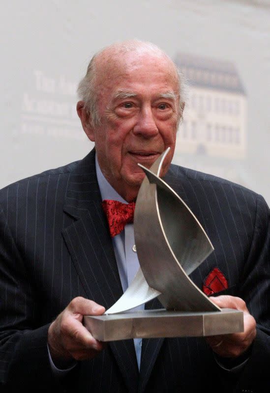 FILE PHOTO: Former U.S. Secretary of State Shultz poses with the 'Henry A. Kissinger Prize' trophy in Berlin