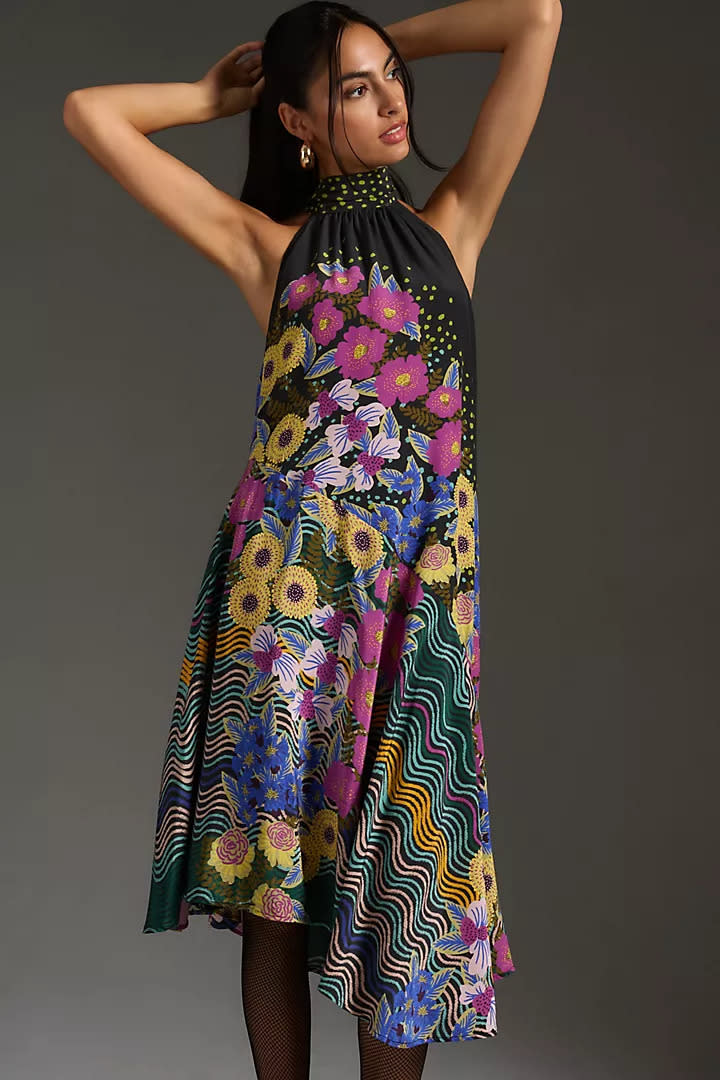 By Anthropologie Halter Asymmetrical Silk Midi Dress. Image via Anthropologie.