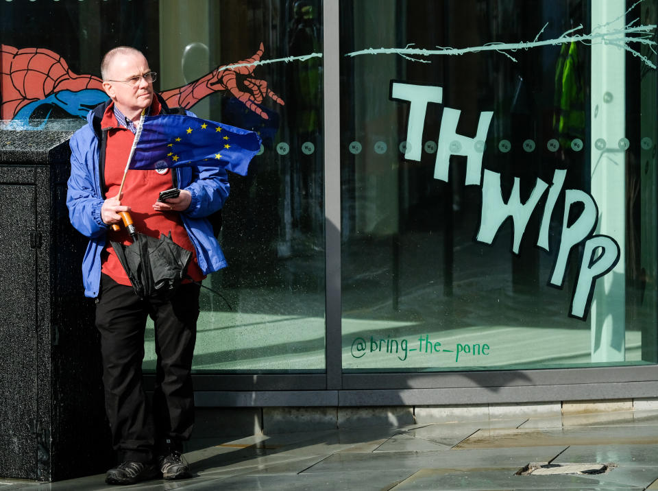 MANCHESTER, ENGLAND - SEPTEMBER 28:  A man holds a European Union flag as he stands outside the Midland hotel ahead of the Conservative Party Conference on September 28, 2019 in Manchester, England. Despite Parliament voting against a government motion to award a recess, the Conservative Party Conference is still going ahead. Parliament will continue with its business for the duration. (Photo by Ian Forsyth/Getty Images)