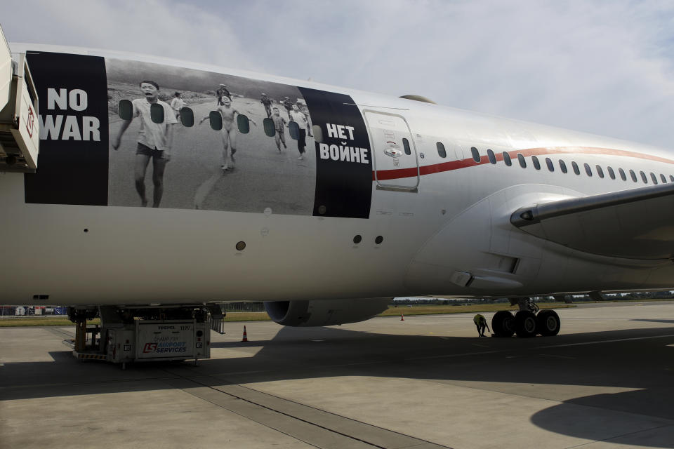 A Boeing 787 Dreamliner carrying Ukrainian refugees is seen at Frederic Chopin Airport in Warsaw, Poland, Monday, July 4, 2022. Kim Phuc, the girl in the famous 1972 Vietnam napalm attack photo, on Monday escorted 236 refugees from the war in Ukraine on a flight from Warsaw to Canada. Phuc’s iconic Associated Press photo in which she runs with her napalm-scalded body exposed, was etched on the private NGO plane that is flying the refugees to the city of Regina, the capital of the Canadian province of Saskatchewan. (AP Photo/Michal Dyjuk)