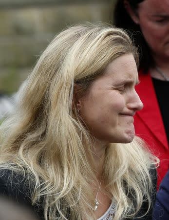 Kim Leadbeater, the sister of murdered Labour Party MP Jo Cox, reacts as she looks at floral tributes left in Birstall, Britain June 18, 2016. Danny Lawson/Press Association via REUTERS