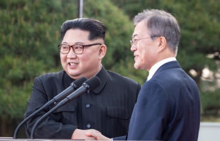 South Korean President Moon Jae-in and North Korean leader Kim Jong Un shake hands at the truce village of Panmunjom inside the demilitarized zone separating the two Koreas, South Korea, April 27, 2018.   Korea Summit Press Pool/Pool via Reuters