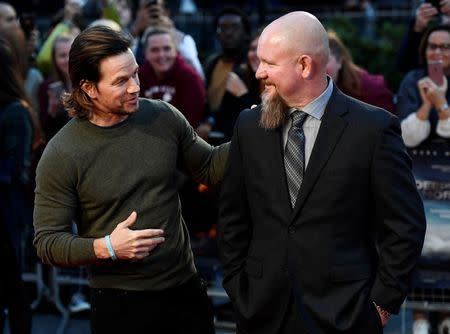 Actor Mark Wahlberg (L) poses alongside Mike Williams as he arrives at the European premiere of "Deepwater Horizon" at Leicester Square in London, Britain September 26, 2016. REUTERS/Dylan Martinez