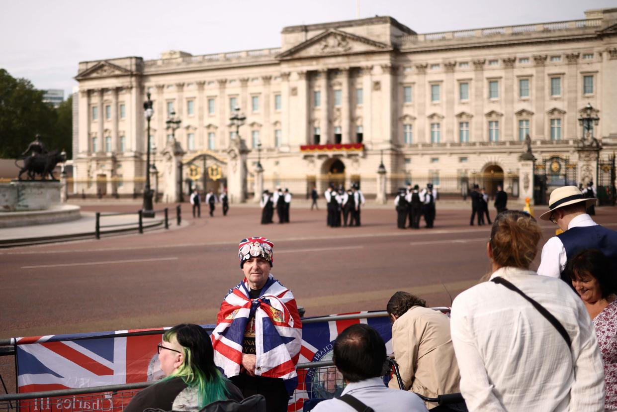 Royal super fan John Loughery poses at the Queen Victoria Memorial in front of Buckingham Palace (AFP via Getty Images)