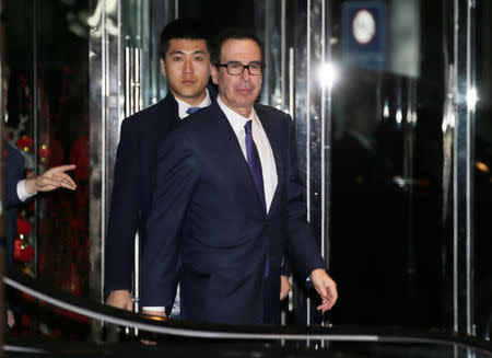 U.S. Treasury Secretary Steven Mnuchin, a member of the U.S. trade delegation to China, is followed by a Chinese security personnel upon his arrival at a hotel after talks with Chinese officials in Beijing, China February 14, 2019. REUTERS/Jason Lee
