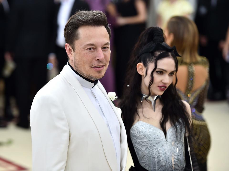 Elon Musk wearing a white shirt while attending the Met Gala with his ex-partner Grimes.