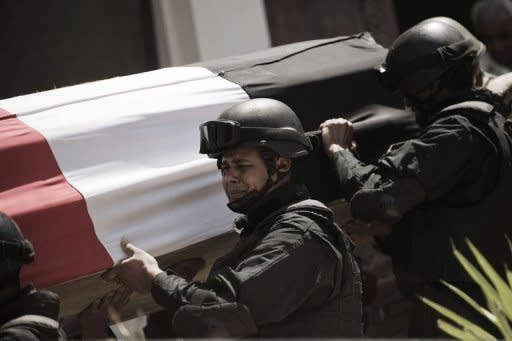 Egyptian soldiers carry the coffin of one of their comrade, Samir Anwar Ismail during his funeral in Cairo on May 5. Ismail -- a member of Egypt's special forces unit -- was killed on May 4 during clashes at the Al-Nur mosque in central Cairo, members of his unit told AFP. Egypt's military ruler has attended an unprecedented public funeral for a soldier killed in clashes with protesters