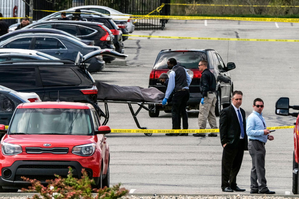 Officials load a body into a vehicle at the site of a mass shooting at a FedEx facility in Indianapolis, Indiana, on April 16, 2021. (Jeff Dean / AFP via Getty Images file)