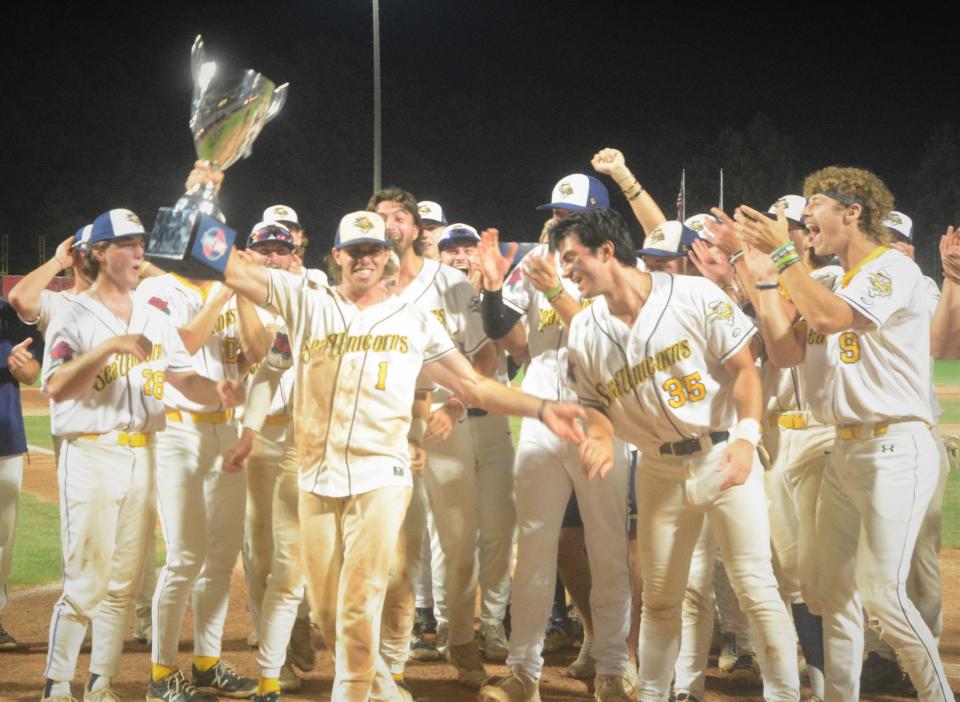 Norwich Sea Unicorns' Johnny Knox celebrates with the Futures League championship trophy Sunday night at Dodd Stadium. Knox was selected the Championship Series MVP.