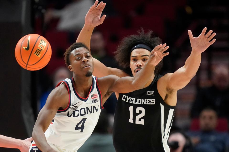 Connecticut guard Nahiem Alleyne (4) and Iowa State forward Robert Jones (12) battle for the ball during the first half of Sunday's game in Portland, Ore.