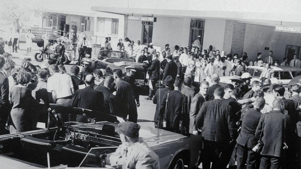 spectators gathering around building