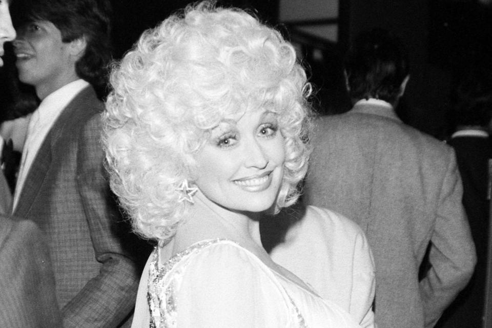 <p>Pierre-Gilles Vidoli/WWD/Penske Media via Getty</p> Dolly Parton at the 1984 premiere of 