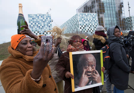 Supporters of former Ivory Coast President Laurent Gbagbo rally outside the International Criminal Court in The Hague, Netherlands, January 15, 2019. Peter Dejong/Pool via REUTERS