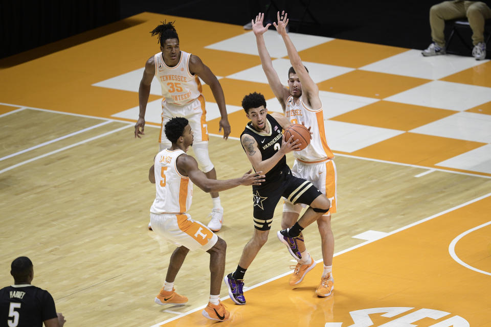 Tennessee's Josiah-Jordan James (5) and John Fulkerson (10) double team Vanderbilt guard Scotty Pippen Jr. (2) during an NCAA college basketball game at Thompson-Boling Arena in Knoxville, Tenn., Saturday, Jan. 16, 2021. (Calvin Mattheis/Knoxville News Sentinel via AP, Pool)