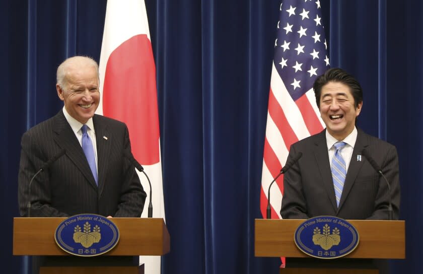U.S. Vice President Joe Biden and Japanese Prime Minister Shinzo Abe smile together during a joint press conference following their meeting at Abe's official residence in Tokyo Tuesday, Dec. 3, 2013. Biden voiced strong opposition Tuesday to China's new air defense zone above a set of disputed islands, showing a united front with an anxious Japan as tension in the region simmered. Standing side by side in Tokyo with Abe, Biden said the U.S. is "deeply concerned" about China's attempt to unilaterally change the status quo in the East China Sea. (AP Photo/Koji Sasahara)