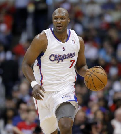 In this Dec. 8, 2012, photo, Los Angeles Clippers&amp;#39; Lamar Odom brings the ball up in an NBA basketball game against the Phoenix Suns in Los Angeles. The New York Knicks have signed Odom, who was out of the league this season. The move gives new president Phil Jackson an offseason to look at the versatile forward who thrived in his system. Odom helped the Los Angeles Lakers win NBA titles in 2009 and 2010, and was the Sixth Man of the Year in 2011, Jackson&amp;#39;s final season as coach. (AP Photo/Jae C. Hong)