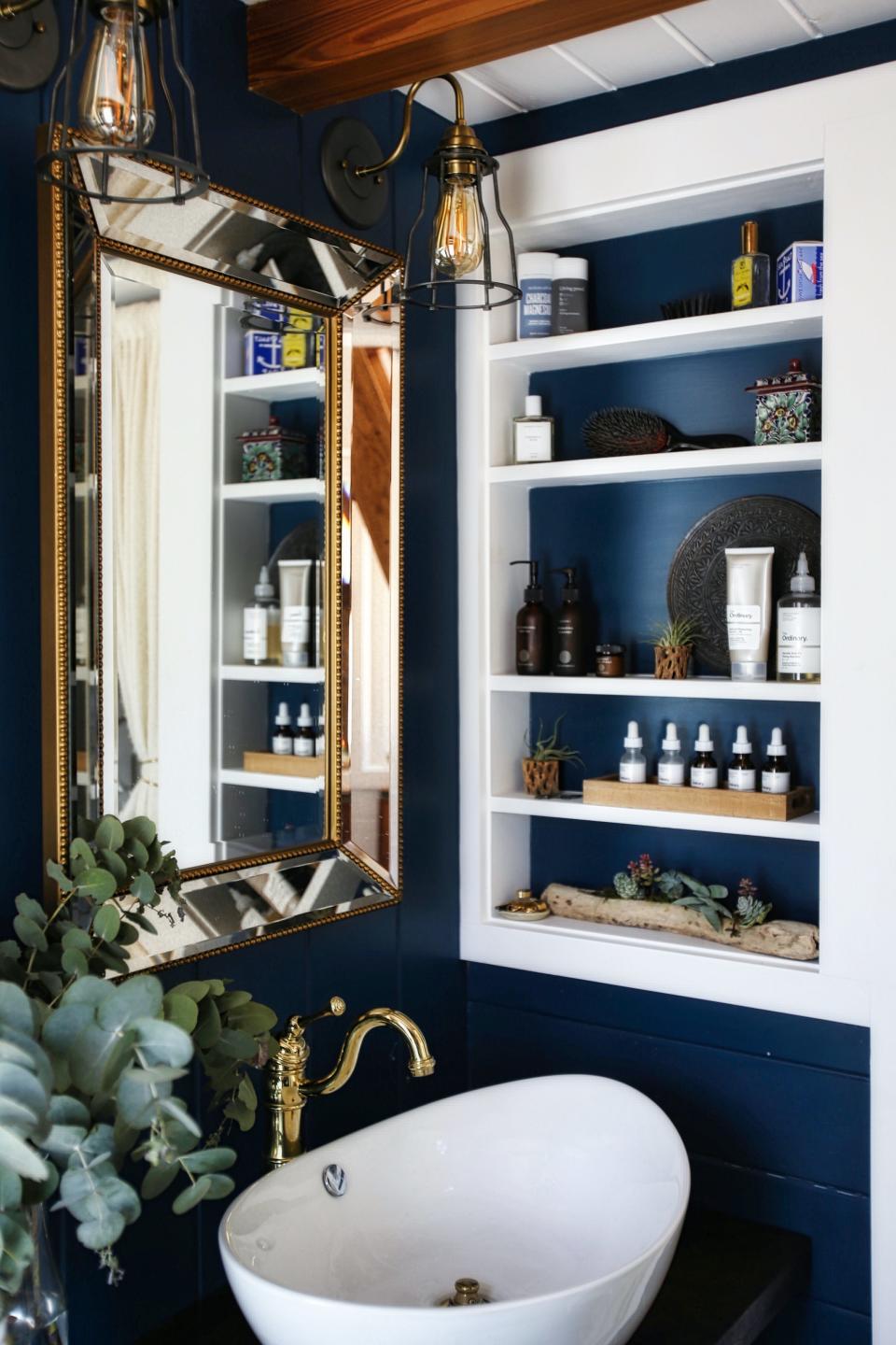 Bela Fishbeyn bathroom with sink and gold mirror