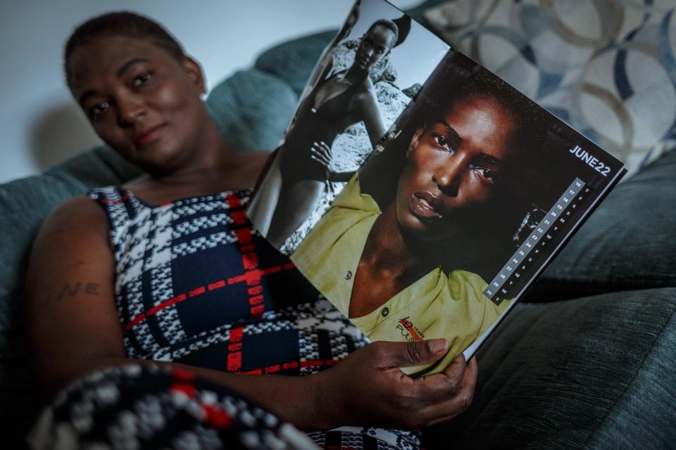 Nadine Willis in a portrait holding a magazine with an image from her modeling days at her home in Delray Beach, Fla., on December 19, 2022.