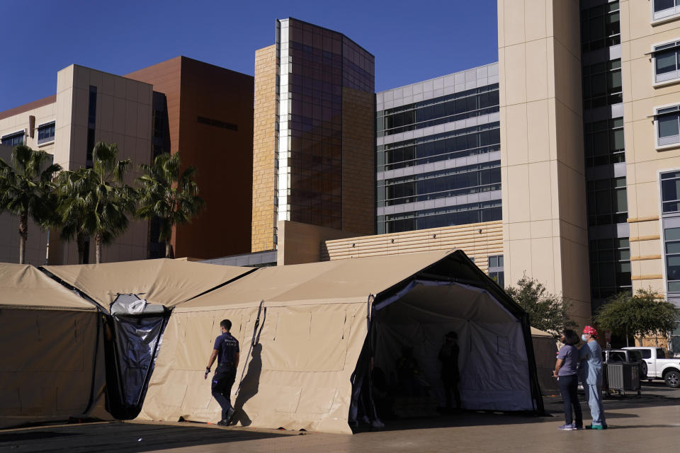 A mobile field hospital is set up at UCI Medical Center, Monday, Dec. 21, 2020, in Orange, Calif. California's overwhelmed hospitals are setting up makeshift extra beds for coronavirus patients, and a handful of facilities in hard-hit Los Angeles County are drawing up emergency plans in case they have to limit how many people receive life-saving care. (AP Photo/Jae C. Hong)