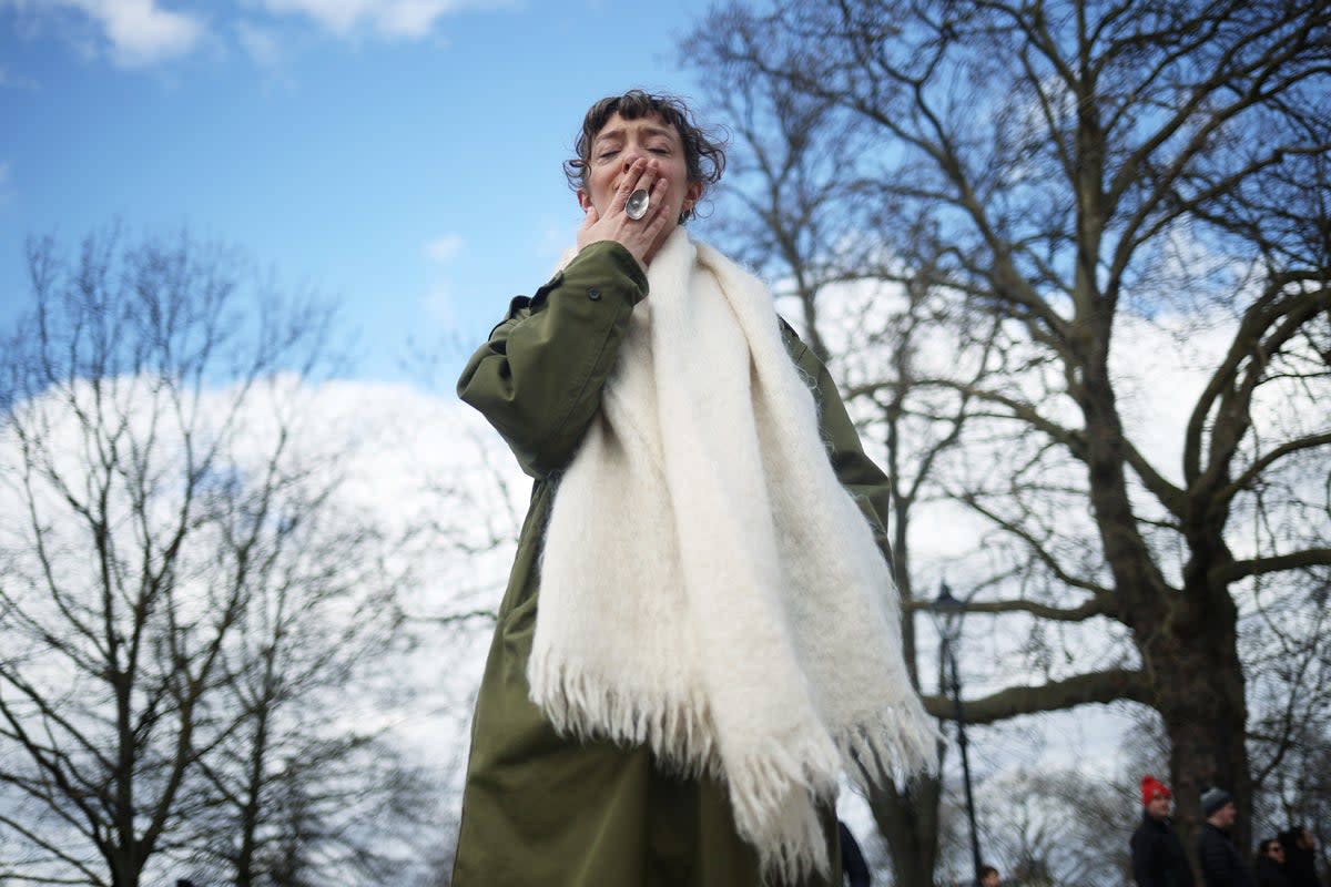 Tributes paid to Sarah Everard at Clapham Common vigil: A woman reacts at a memorial site (Reuters)