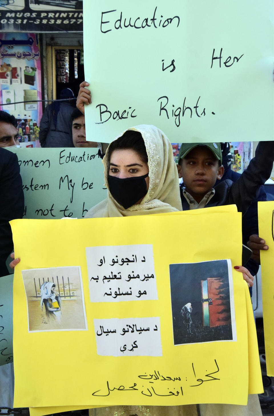 Afghan university students hold placards during a protest against the ban on university education for women, in Quetta, Pakistan, Saturday, Dec. 24, 2022. (AP Photo/Arshad Butt)