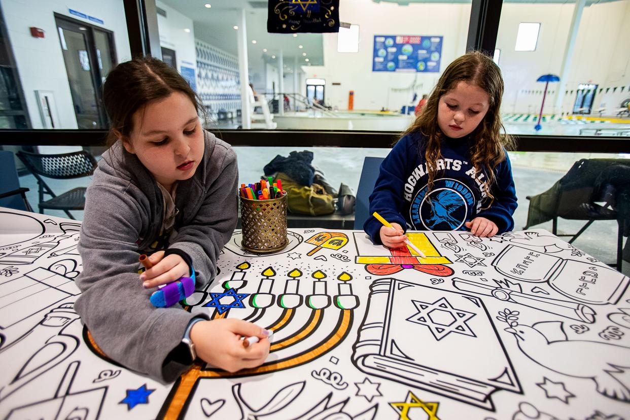10-year-old Madison Fox, left, and her sister, 7-year-old Peyton Fox enjoyed coloring during a Hanukkah celebration at the Trager Family Jewish Community Center on Monday, Dec. 19, 2022.