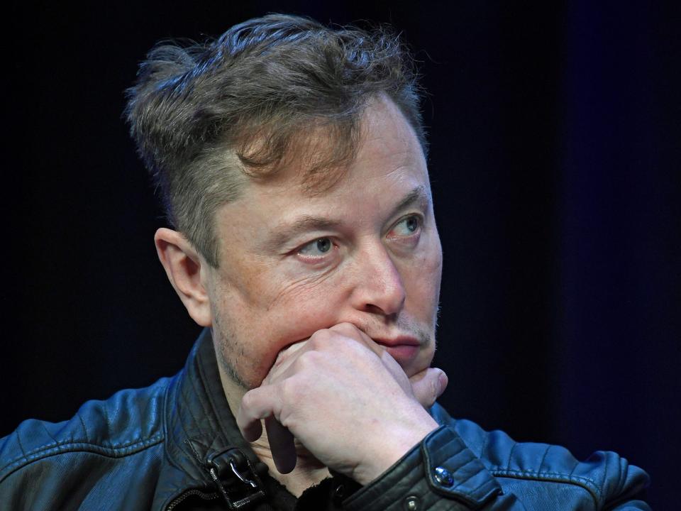 Elon Musk SpaceX Tesla CEO holds hand to face thinking