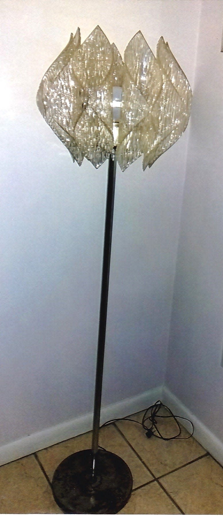 This floor lamp was likely made after World War II. The fact that it has no manufacturer’s labels, etc., indicates it was made as a generic look alike, perhaps in the manner of an Italian designer.