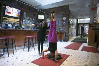 <p>Yahoo Global News Anchor Katie Couric does a headstand with Olympic gold medalist Simone Biles after an interview at John’s Pizzeria in New York City on Nov. 18. (Gordon Donovan/Yahoo News) </p>