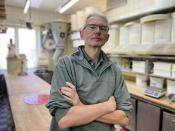 Baker Engelbert Schlechtrimen poses for a photo in the factory room of his bakery in Cologne, Germany, Wednesday, Sept. 21, 2022. For 90 years, the family of Engelbert Schlechtrimen has been baking wheat rolls, rye bread, apple, cheese and chocolate cakes in Cologne, but next month they'll turn off the ovens for good because they can no longer afford the rising energy prices resulting from Russia's war in Ukraine. (AP Photo/Daniel Niemann)