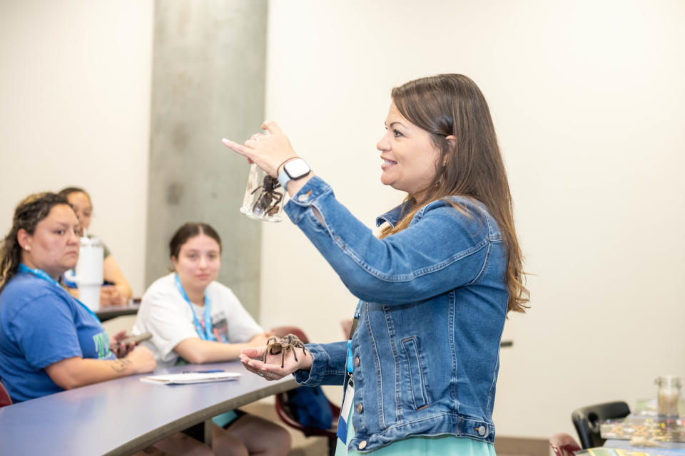 ME by the SEa presenter Chelsea Watson presents to Coastal Bend educators about incorporating animals into the classroom, holding a spider Friday at Texas A&M University-Corpus Christi.