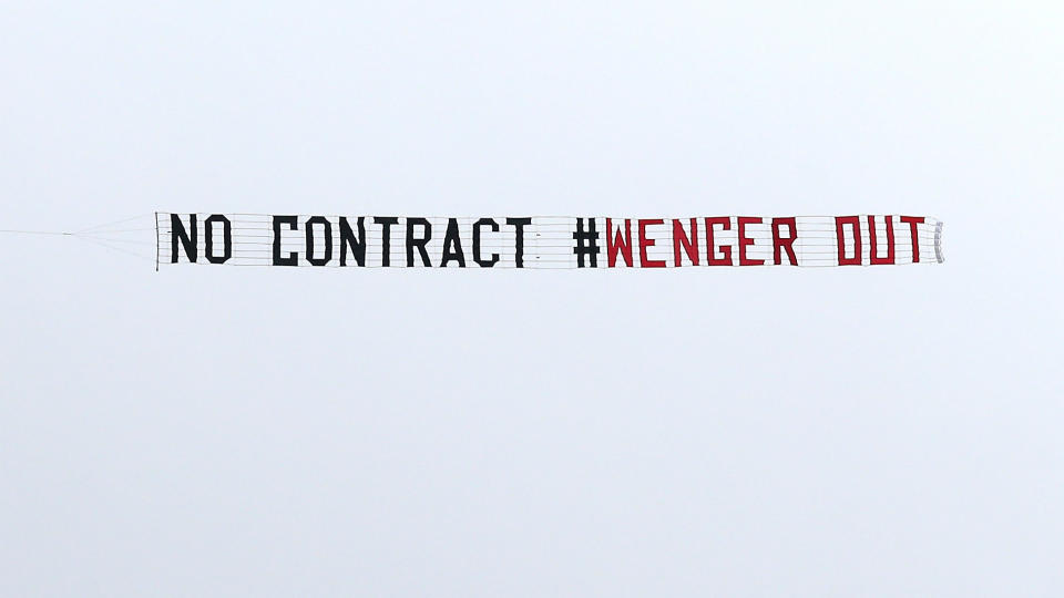 <p>General view of a plane flying overhead with a message directed at Arsenal manager Arsene Wenger before the match </p>