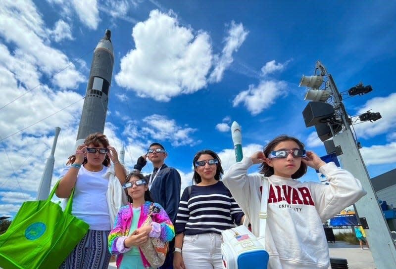 The Patina family visiting from Polk County trying on the glasses they were just given at KSC visitor complex.