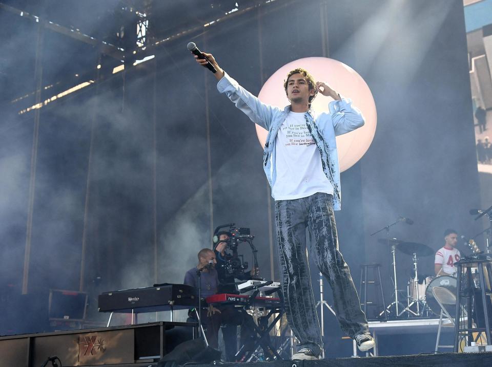 Man plays on stage during a concert